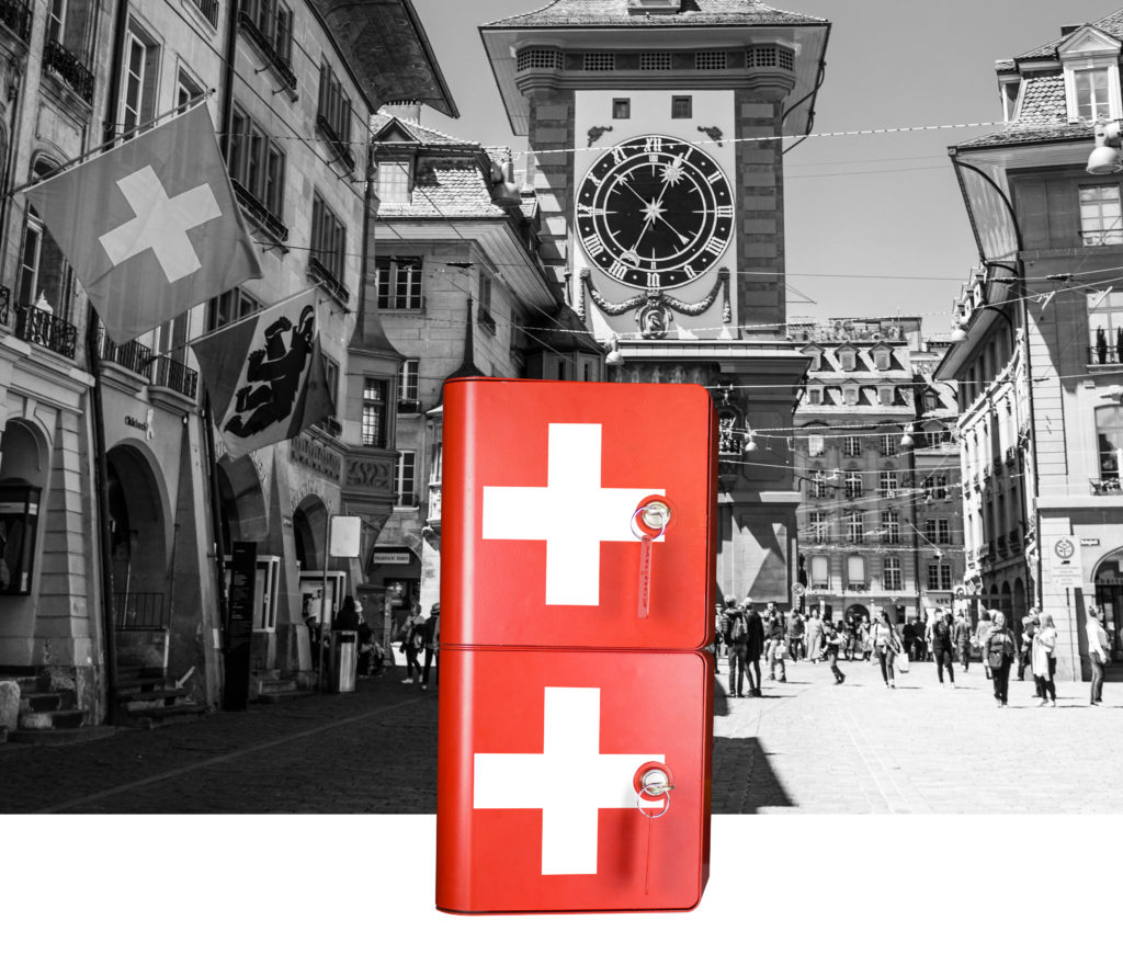 Borne de recharge pour téléphones rouge avec sticker blanc suisse